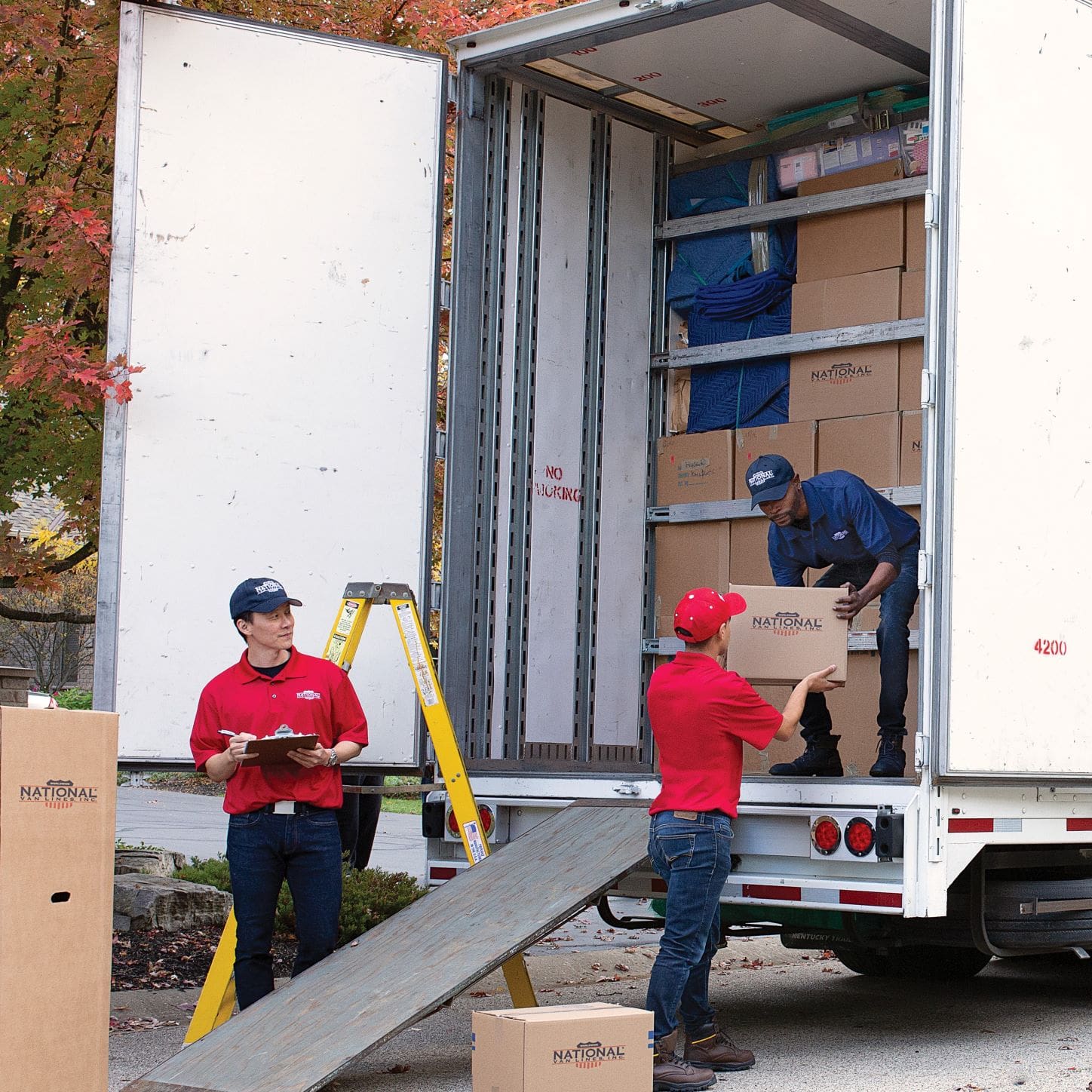 National Van Lines crew unloading boxes from a truck
